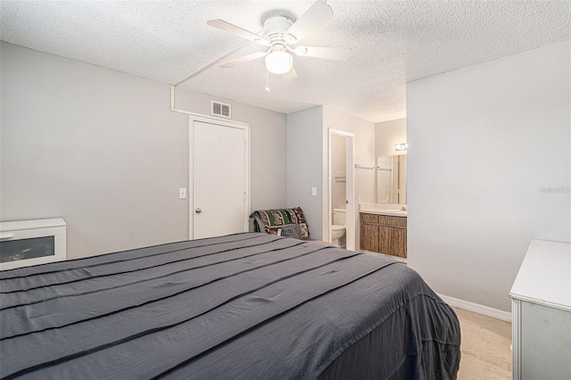 455 Alt 19 S Unit 268, Palm Harbor, FL 34683 - bedroom with a textured ceiling, ceiling fan, and ensuite bath
