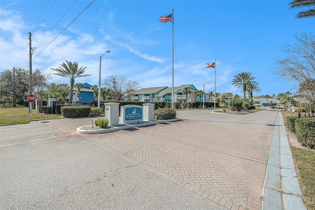 455 Alt 19 S Unit 268, Palm Harbor, FL 34683 - view of decorative road featuring traffic signs, street lighting, curbs, and a residential view