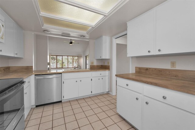 kitchen with electric stove, white cabinets, a sink, light tile patterned flooring, and dishwasher