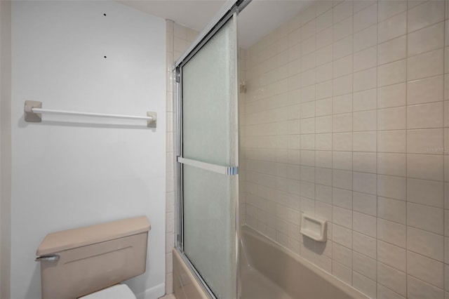 bathroom with shower / bath combination with glass door and toilet