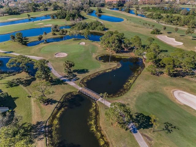 birds eye view of property with a water view and golf course view