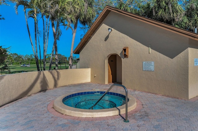 view of swimming pool featuring a community hot tub and a patio