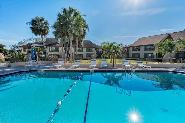 pool featuring a patio area and fence