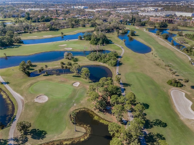 birds eye view of property featuring view of golf course and a water view