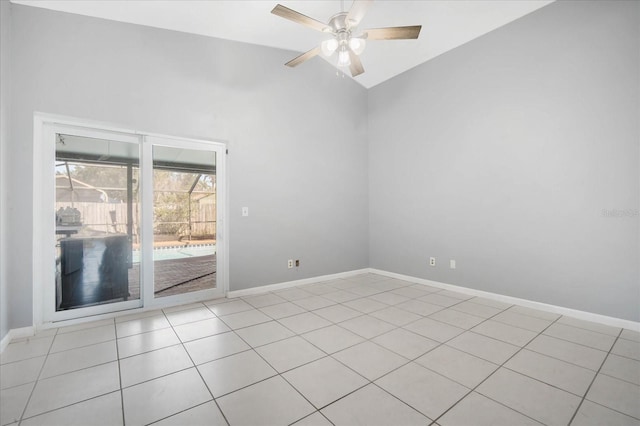 tiled spare room featuring vaulted ceiling and ceiling fan