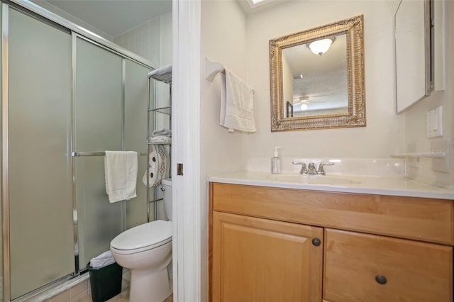 bathroom with walk in shower, vanity, and toilet