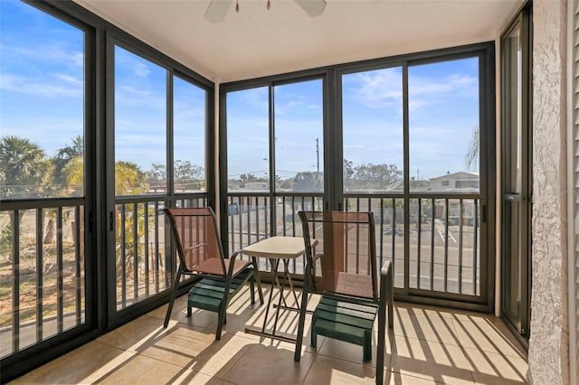 sunroom / solarium with a wealth of natural light and ceiling fan