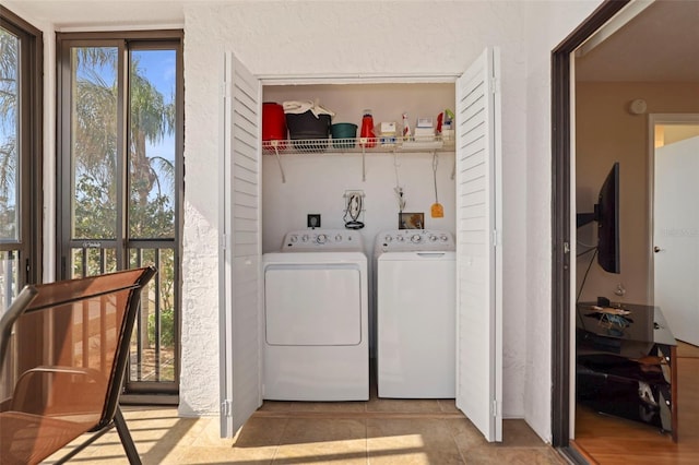 clothes washing area featuring washing machine and clothes dryer and light tile patterned floors