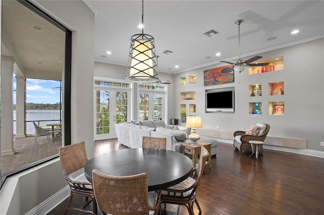 dining room with crown molding, dark hardwood / wood-style floors, ceiling fan, and french doors