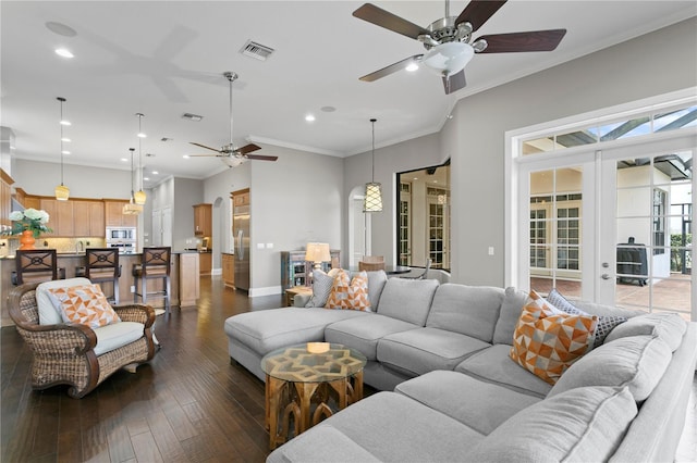 living room featuring crown molding, ceiling fan, dark hardwood / wood-style flooring, and french doors