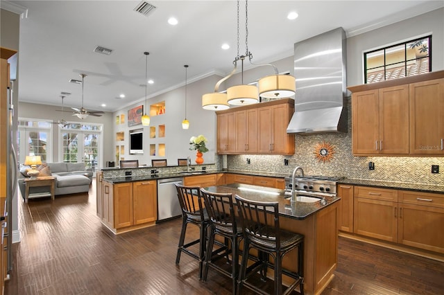 kitchen featuring pendant lighting, dishwasher, a breakfast bar area, kitchen peninsula, and wall chimney exhaust hood