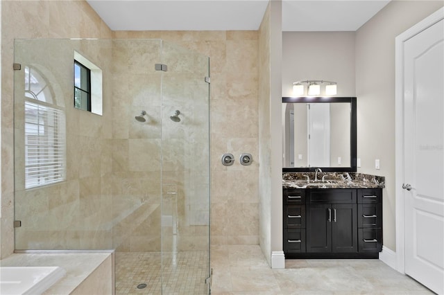 bathroom featuring vanity, a healthy amount of sunlight, and separate shower and tub