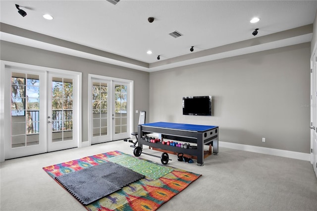 recreation room with french doors and light carpet