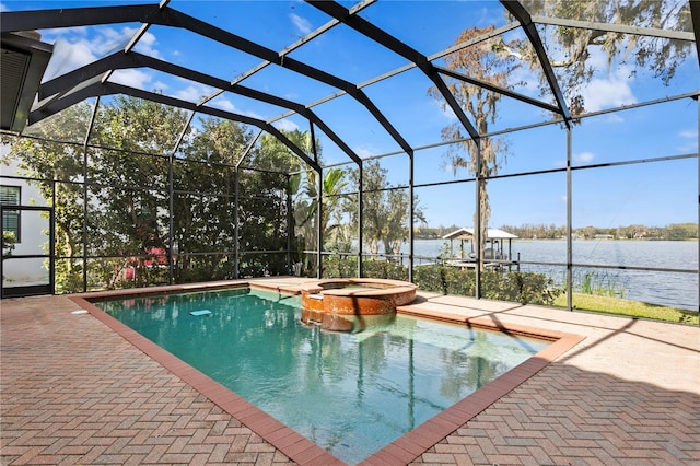 view of pool featuring a patio, a lanai, a water view, and an in ground hot tub