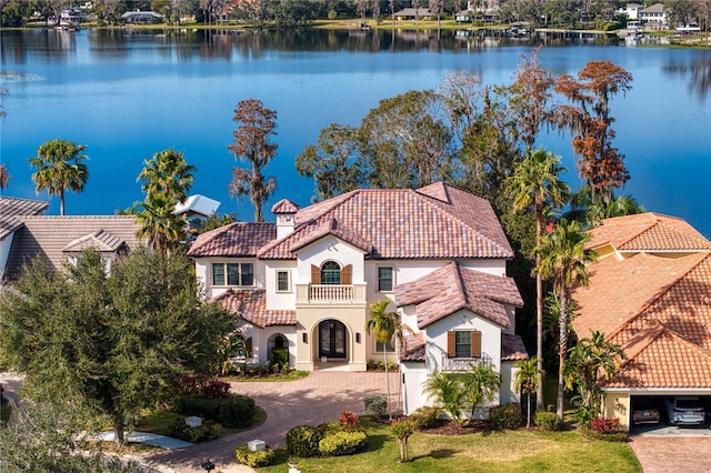 1903 Haven Bnd, Tampa, FL 33613 - view of front of home with a tile roof, a balcony, stucco siding, and decorative driveway