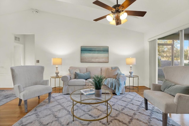 living room featuring vaulted ceiling, ceiling fan, and hardwood / wood-style floors