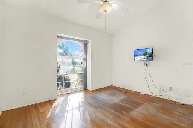 empty room with hardwood / wood-style floors and ceiling fan