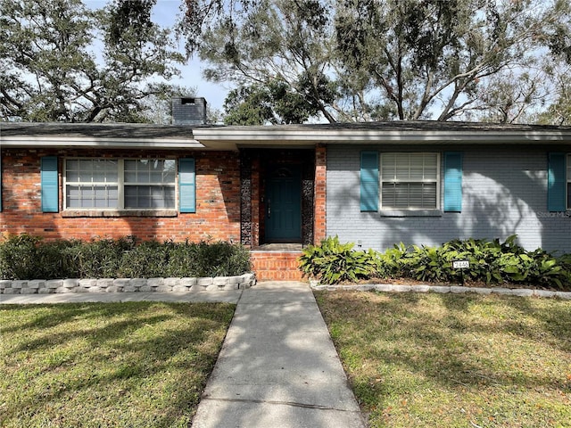 ranch-style home with cooling unit and a front yard