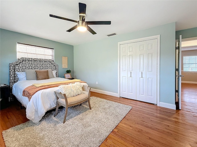 bedroom featuring hardwood / wood-style flooring, ceiling fan, and a closet