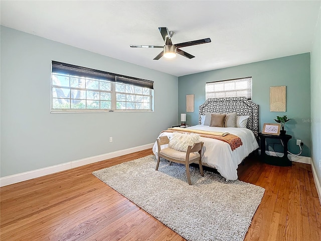 bedroom with ceiling fan and hardwood / wood-style floors