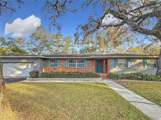 ranch-style house featuring a garage and a front yard