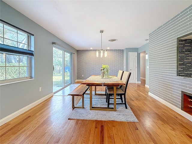 dining area with an inviting chandelier and light wood-type flooring