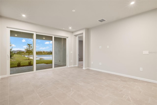 spare room featuring a water view