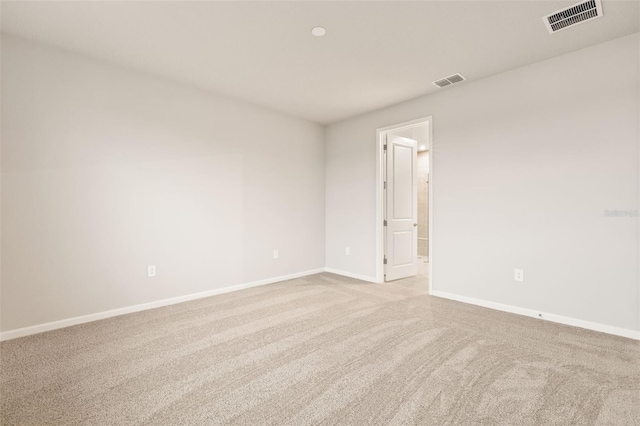 unfurnished room featuring light carpet