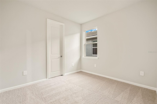 unfurnished room with light colored carpet