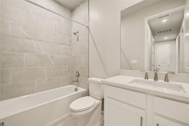 full bathroom with tiled shower / bath combo, vanity, and toilet