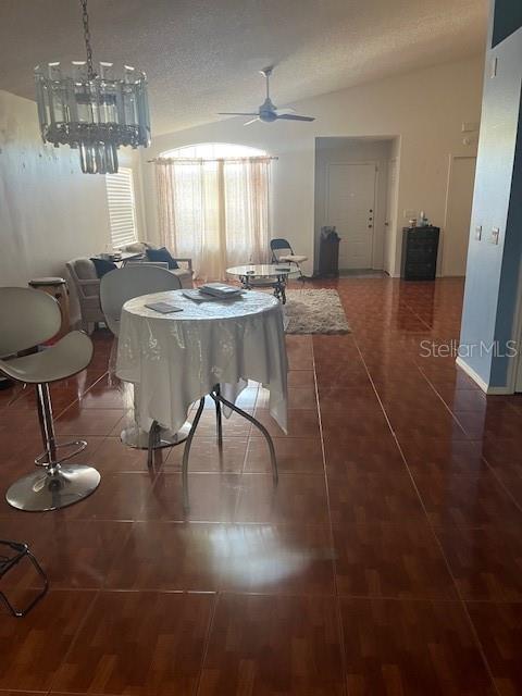 dining space featuring ceiling fan and vaulted ceiling