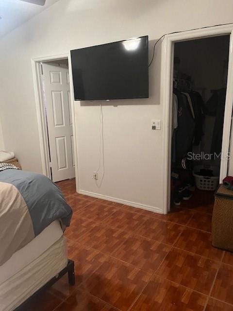 bedroom with lofted ceiling, a walk in closet, and a closet