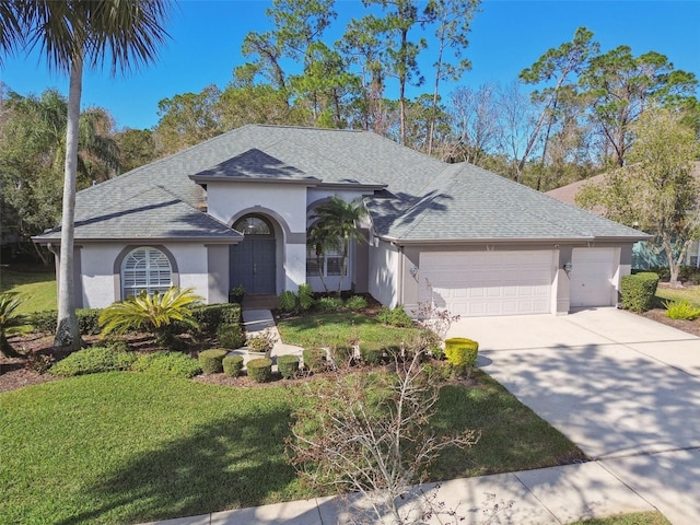 ranch-style house featuring a garage and a front yard