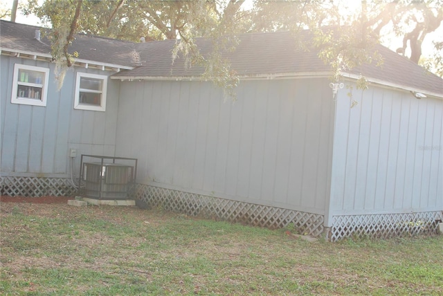 view of home's exterior with a yard and central air condition unit