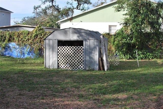 view of outdoor structure featuring a lawn