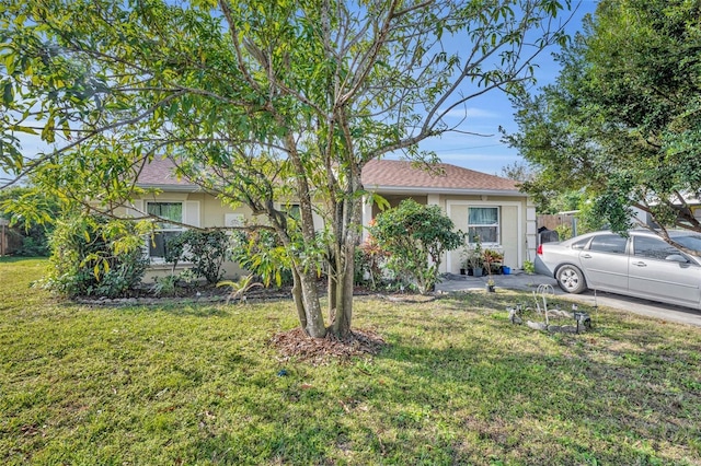 view of property hidden behind natural elements featuring a front yard