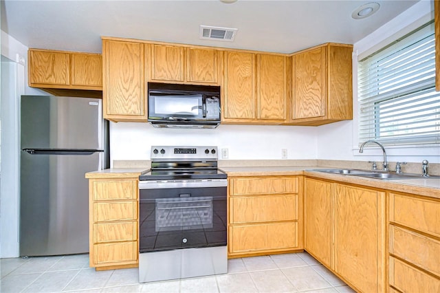 kitchen featuring sink, stainless steel appliances, and light tile patterned flooring