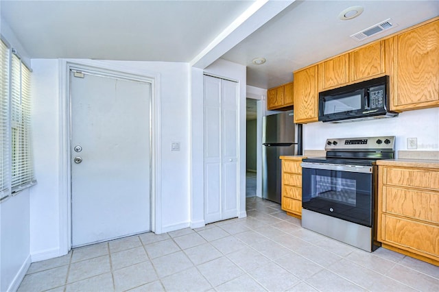 kitchen with light tile patterned floors and appliances with stainless steel finishes