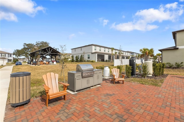 view of patio with a grill, a gazebo, and exterior kitchen