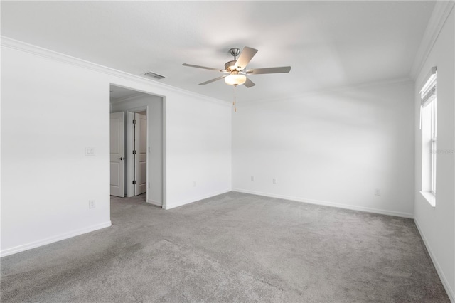 carpeted empty room featuring ornamental molding and ceiling fan