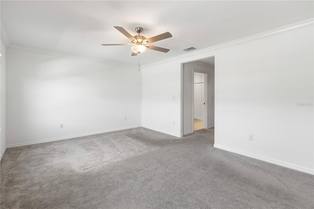 carpeted spare room featuring crown molding and ceiling fan