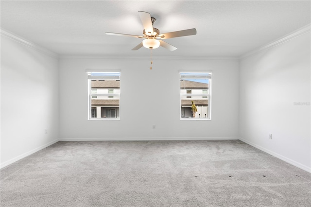 carpeted empty room with crown molding, a healthy amount of sunlight, and ceiling fan