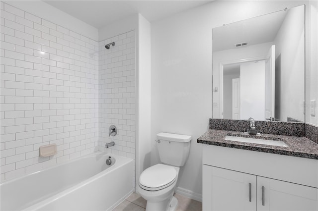 full bathroom featuring vanity, tiled shower / bath combo, tile patterned floors, and toilet