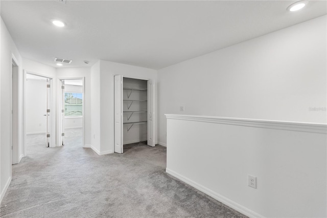 empty room featuring light colored carpet