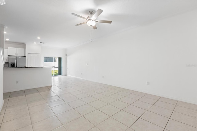 unfurnished living room with crown molding, ceiling fan, and light tile patterned flooring