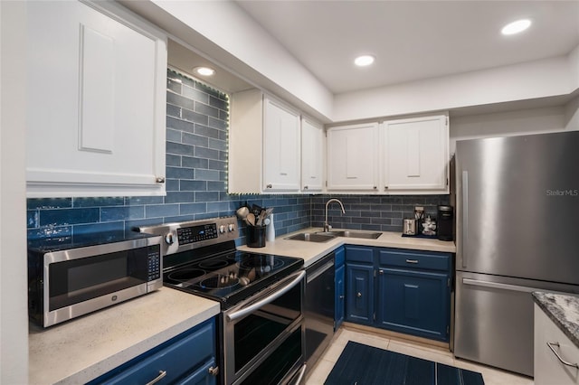 kitchen with white cabinetry, stainless steel appliances, and blue cabinets