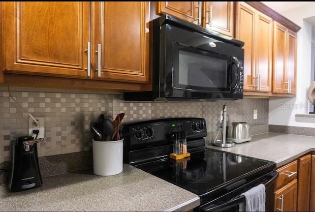 kitchen featuring tasteful backsplash and black appliances