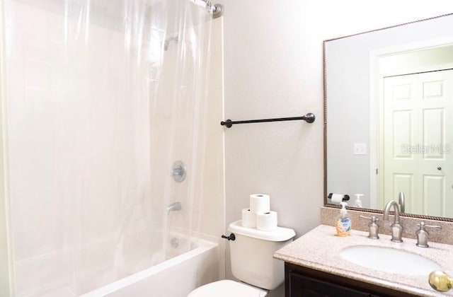 full bathroom featuring vanity, toilet, and shower / bath combo with shower curtain