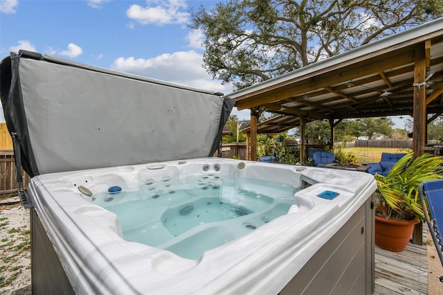 wooden deck featuring a hot tub