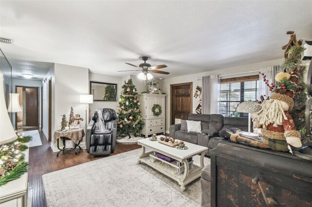 living room with dark hardwood / wood-style floors and ceiling fan